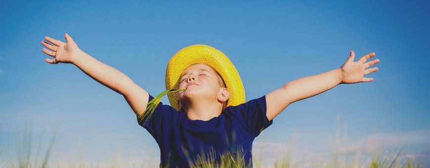 Happy boy  in the middle of wheat fields